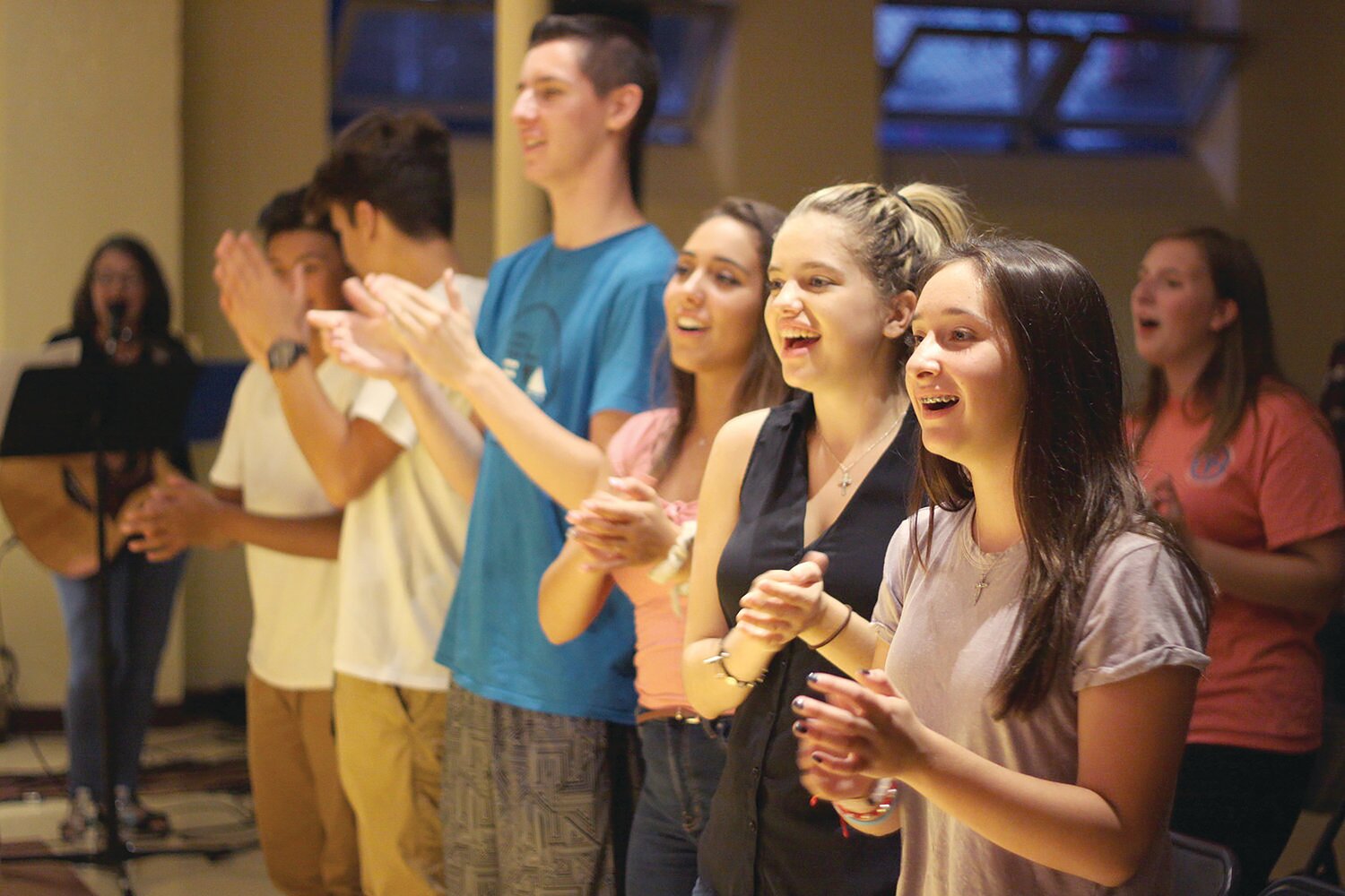 Young people gather at a Glorify event for a night of praise, worship and Eucharistic Adoration at Rejoice in Hope Youth Center, Cranston.